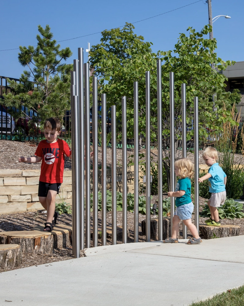 children climbing on landscaping structures