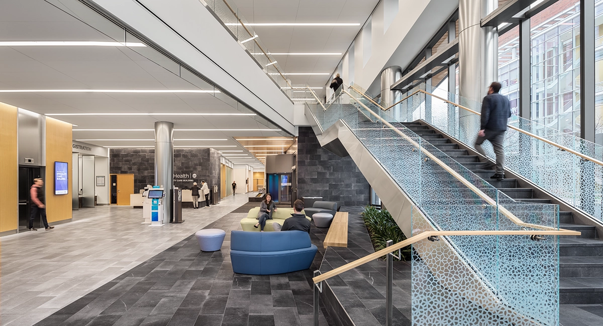 people in lobby and waiting area near stairway