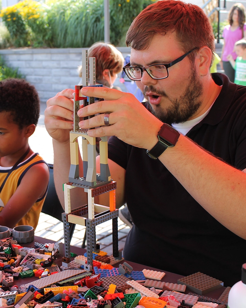 Man building lego structure