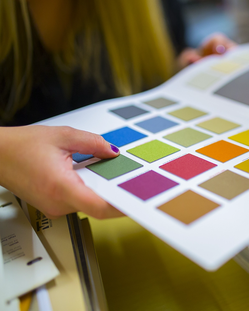 Interior Designer looks at color book