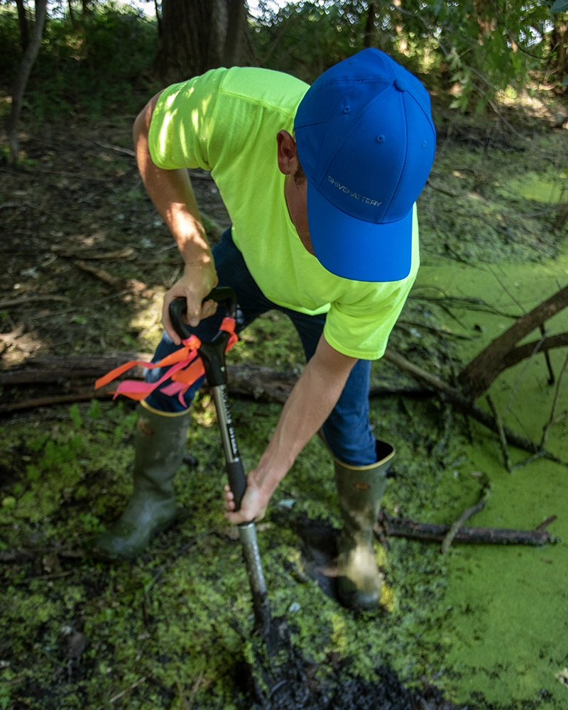 Man taking wetland soil sample