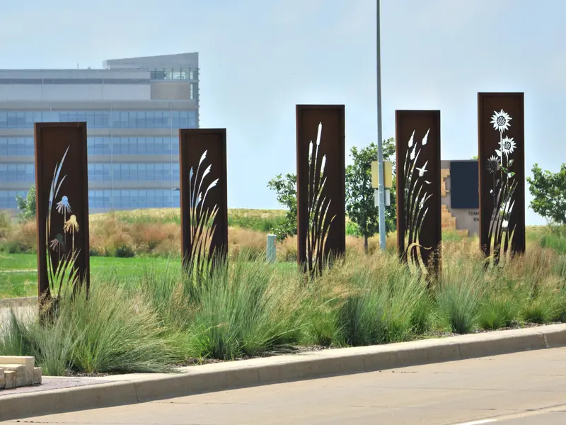 Metal art panels and landscaping along roadside