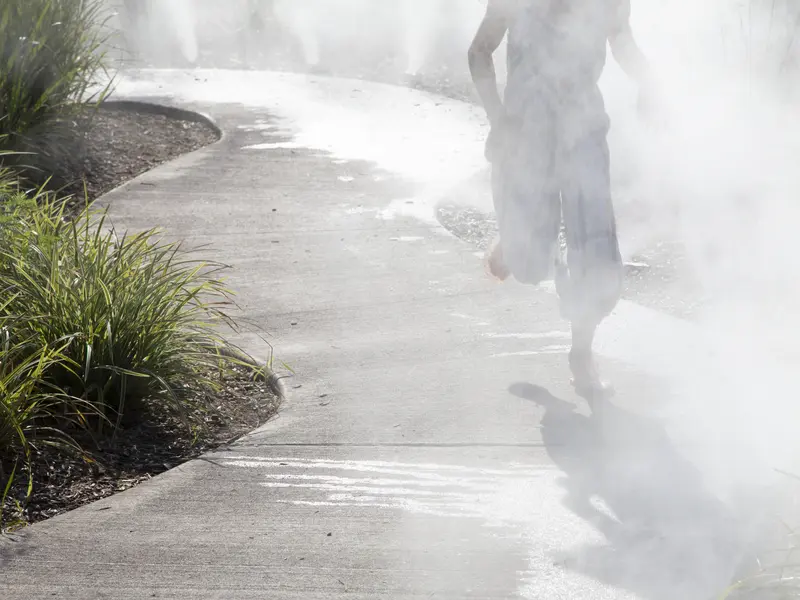 Child running through mist walkway