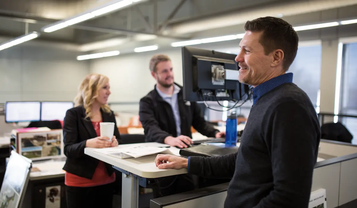 Coworkers working together at a desk space