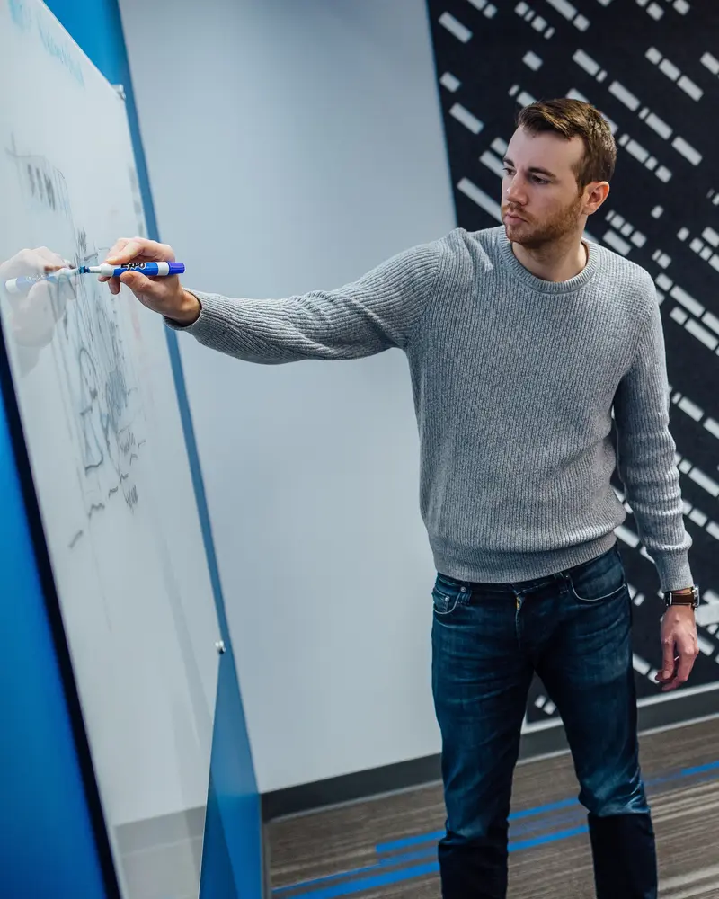 Team member drawing on the white board