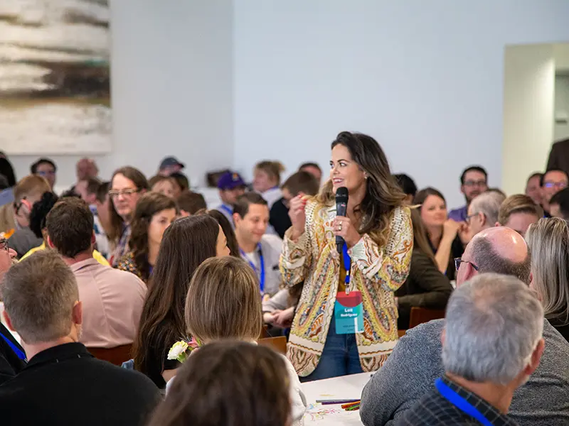 Woman speaking in front of a group at Architecture Swarm