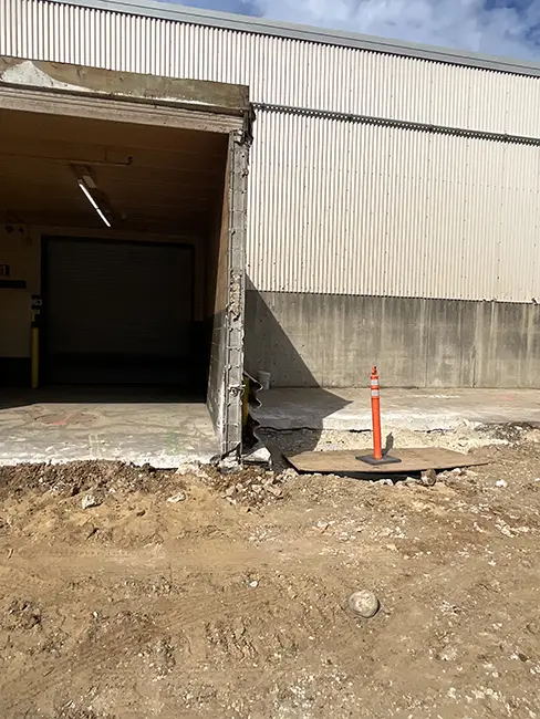 An exposed building where the previous enclosing wall was demolished to construct a building addition at this industrial manufacturing facility.