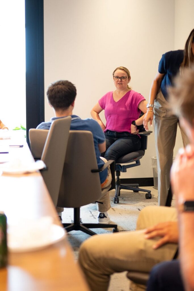 Shive-Hattery Quad Cities coworkers try out the KI chair during a demo in a conference room