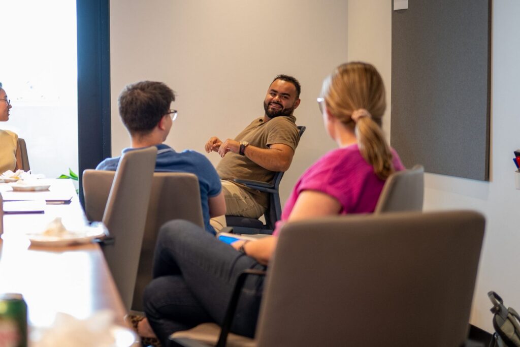 Quad Cities coworkers share a laugh around the conference table during the KI chair demo