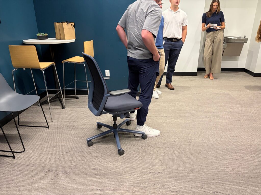 A coworker tries out the KI chair at the Shive-Hattery Quad Cities office